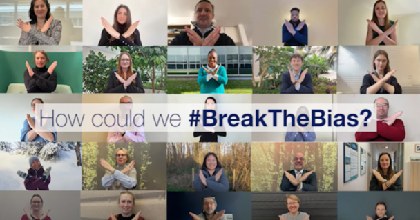 Men and women doing the #BreawTheBias sign for International Women's day
